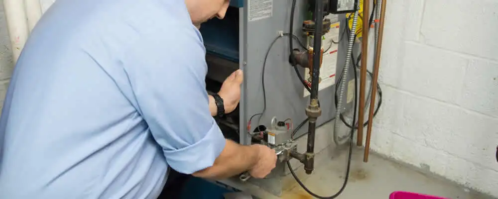Furnace repair technician inspecting and servicing a home heating system in Santa Rosa, CA