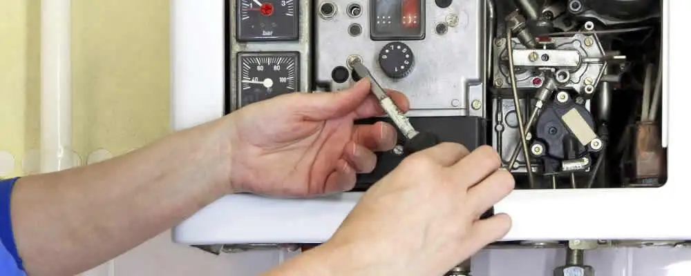 Heating repair technician adjusting boiler controls and components in Santa Rosa, CA