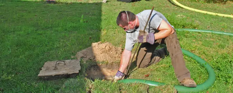 Septic pumping technician servicing a residential septic tank in Santa Rosa, CA