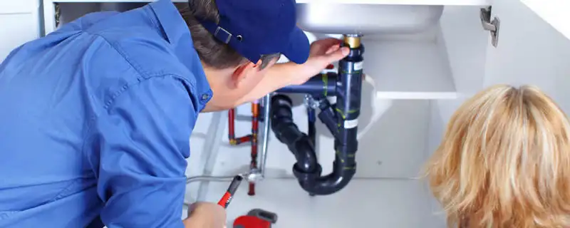 Plumber repairing under-sink drain pipes and fittings in Santa Rosa, CA